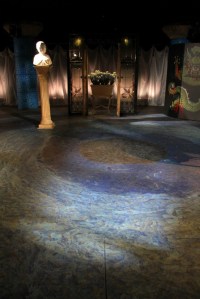 Paintings on the floor assist the audience in the suspension of reality, catapulting them into the dream-logic of the play.